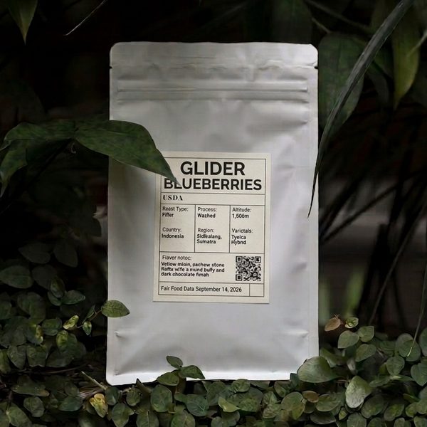 A white bag labelled Glider Blueberries, with a QR code, among leaves